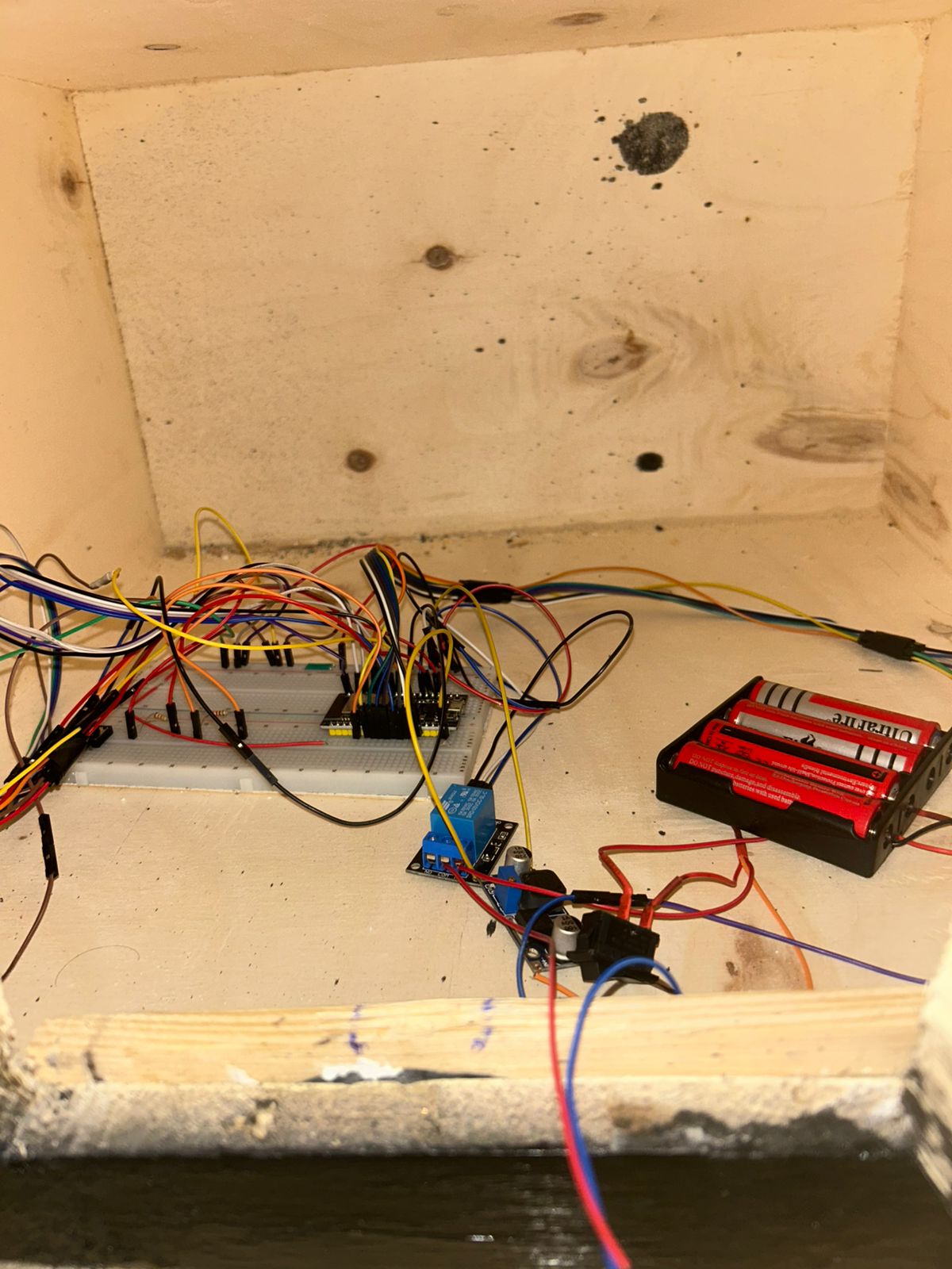 Interior wiring of the Smart Electronic Safe with ESP32, relay, breadboard, and battery pack